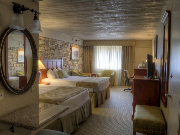 The image shows a hotel room with two beds, a TV, a mirror, a lamp, and a window with curtains in a cozy setting.